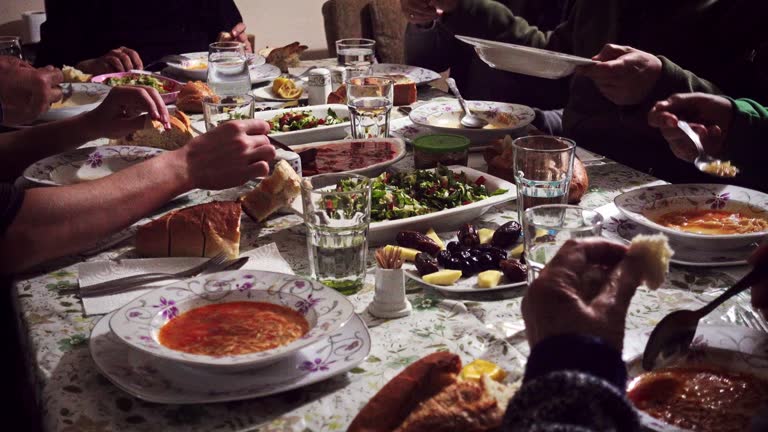 Crowded and hungry muslim family breaking fast in iftar on Ramadan month