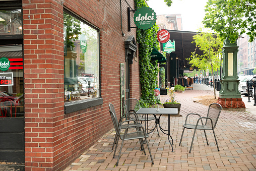 In Omaha, United States the table and chairs outside a small downtown business are empty.