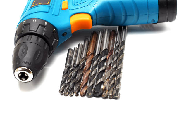 istock closeup of drill machine and set of bits on white background 1221919744