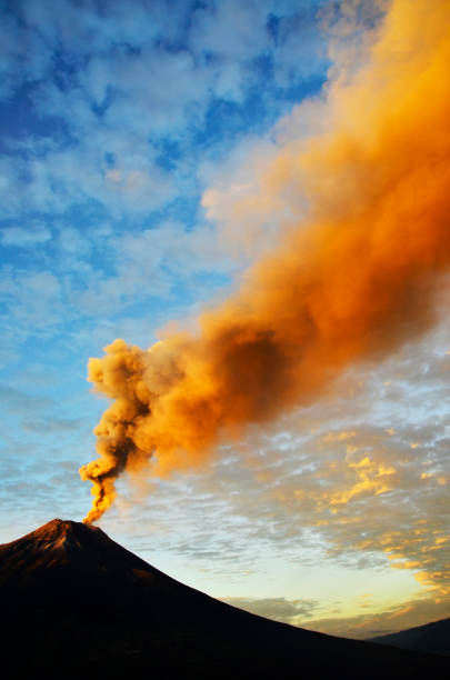 Tungurahua volcano, ecuador Tungurahua,  5,023 meters (16,480 ft) is located in the Cordillera Oriental of the Andes of central Ecuador according to one theory the name Tungurahua is a combination of the Quichua tunguri (throat) and rahua (fire) meaning "Throat of Fire". According to another theory it is based on the Quichua uraua for crater.  Tungurahua is also known as "The Black Giant" and, in local indigenous mythology it is allegedly referred to as Mama Tungurahua ("Mother Tungurahua"). mt tungurahua sunset mountain volcano stock pictures, royalty-free photos & images