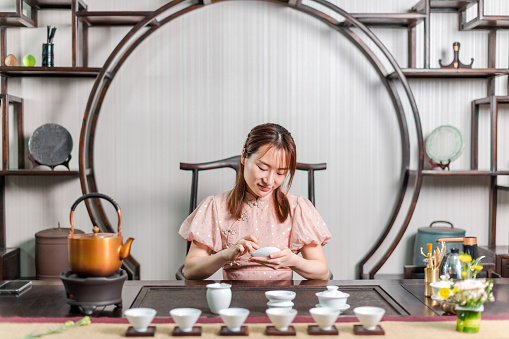 Young women are making tea in traditional Asian ways