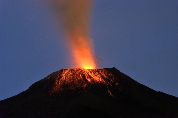 Tungurahua volcano, ecuador Tungurahua,  5,023 meters (16,480 ft) is located in the Cordillera Oriental of the Andes of central Ecuador according to one theory the name Tungurahua is a combination of the Quichua tunguri (throat) and rahua (fire) meaning "Throat of Fire". According to another theory it is based on the Quichua uraua for crater.  Tungurahua is also known as "The Black Giant" and, in local indigenous mythology it is allegedly referred to as Mama Tungurahua ("Mother Tungurahua"). mt tungurahua sunset mountain volcano stock pictures, royalty-free photos & images