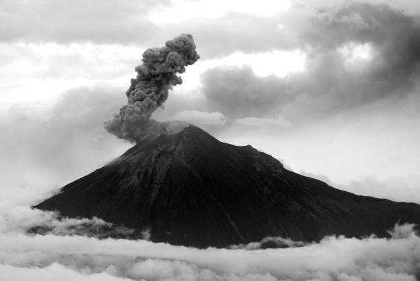 Tungurahua volcano, ecuador Tungurahua,  5,023 meters (16,480 ft) is located in the Cordillera Oriental of the Andes of central Ecuador according to one theory the name Tungurahua is a combination of the Quichua tunguri (throat) and rahua (fire) meaning "Throat of Fire". According to another theory it is based on the Quichua uraua for crater.  Tungurahua is also known as "The Black Giant" and, in local indigenous mythology it is allegedly referred to as Mama Tungurahua ("Mother Tungurahua"). mt tungurahua sunset mountain volcano stock pictures, royalty-free photos & images