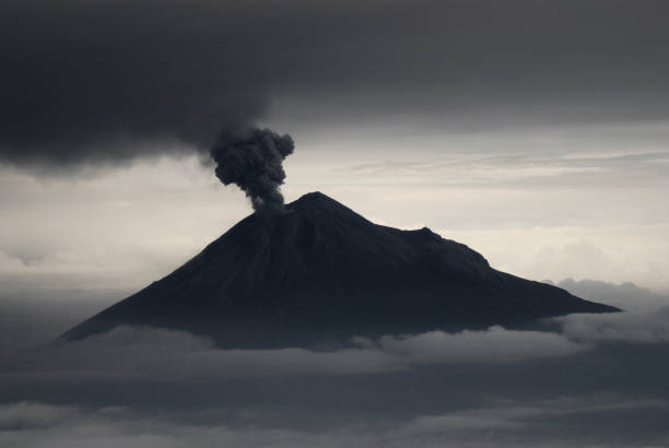 Tungurahua volcano, ecuador Tungurahua,  5,023 meters (16,480 ft) is located in the Cordillera Oriental of the Andes of central Ecuador according to one theory the name Tungurahua is a combination of the Quichua tunguri (throat) and rahua (fire) meaning "Throat of Fire". According to another theory it is based on the Quichua uraua for crater.  Tungurahua is also known as "The Black Giant" and, in local indigenous mythology it is allegedly referred to as Mama Tungurahua ("Mother Tungurahua"). mt tungurahua sunset mountain volcano stock pictures, royalty-free photos & images