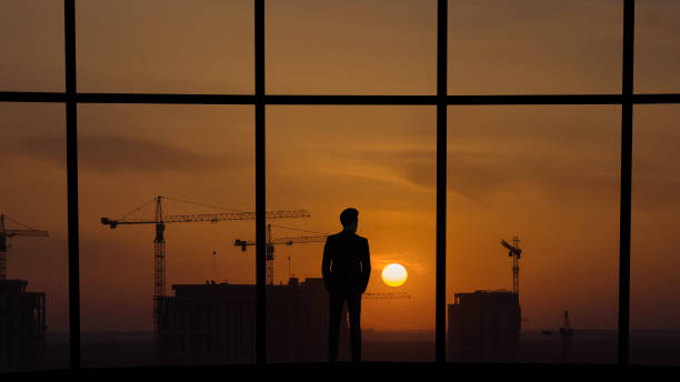 istock The man standing near the panoramic window on building construction background 1221927996