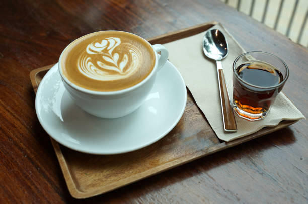 istock Close up hot coffee latte on white coffee cup serving with brown sugar syrup 1221929837