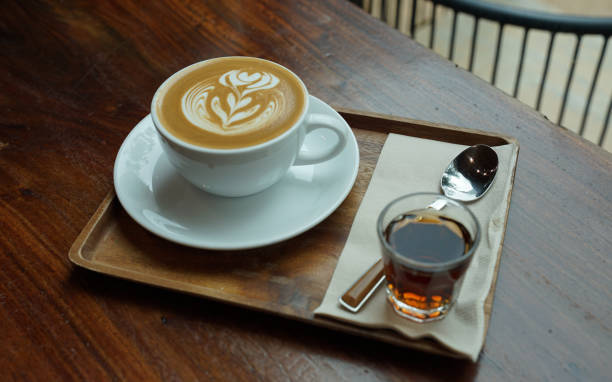istock Close up hot coffee latte on white coffee cup serving with brown sugar syrup 1221929851