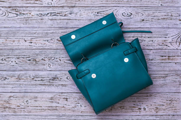 istock Open leather women's bag on a wooden background. 1221929862