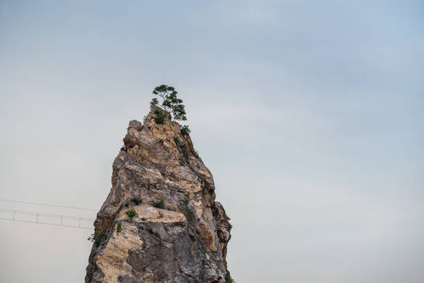 Rock mountain cliff and tree on the top. Beautiful Rock mountain in Khao Ngu Stone Park, Ratchaburi ,Thailand.