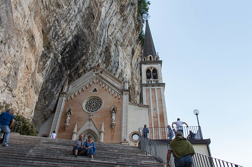 Italy, Ferrara di Monte Baldo - June 03 2018: the front view of the church built in mountains, entrance to The Sanctuary of Madonna della Corona on June 03 2018, Veneto, Italy.