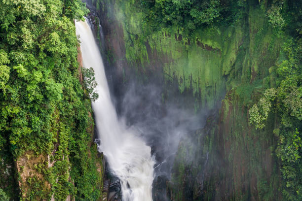 istock Large and high waterfall on mountain cliff in the tropical rain forest. 1221935878
