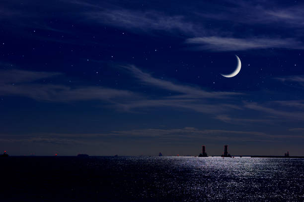 Crescent moon rising over the Tokyo bay area. Crescent moon rising over the Tokyo bay area with copy space. half moon stock pictures, royalty-free photos & images