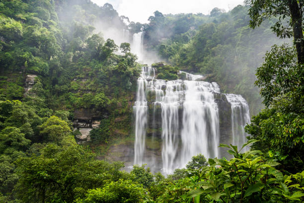 istock Large and high waterfall on mountain cliff in the tropical rain forest 1221937384