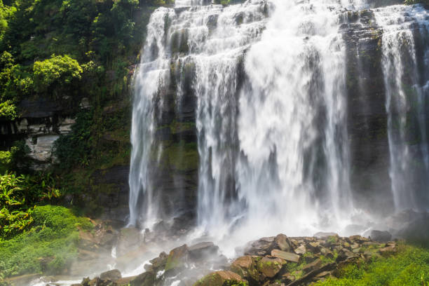 istock Large and high waterfall on mountain cliff in the tropical rain forest 1221937501