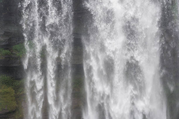 istock Large and high waterfall on mountain cliff in the tropical rain forest 1221937542