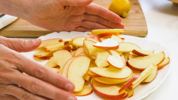 istock Apple slices close up on a plate on white background 1221937674