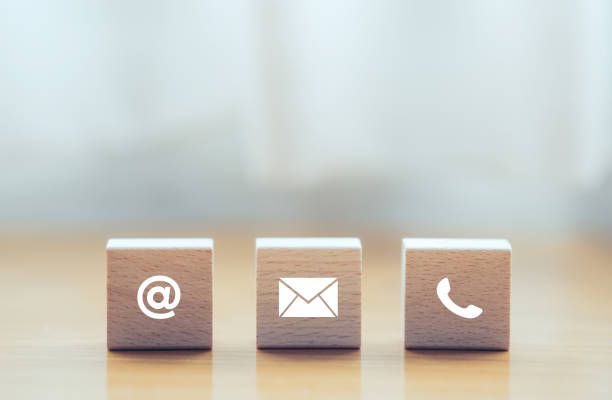 istock contact us icon (phone, email, mail ) on wood cube, customer service and support for self quarantine business working at home for Coronavirus or virus preventing concept 1221940414