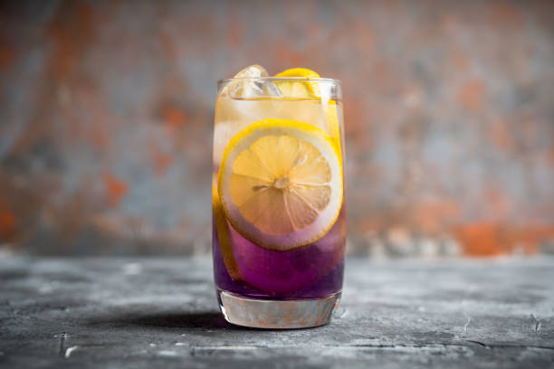 istock Gin based colorful cocktail with lemon and lavender liqueur on the rustic background 1221943788