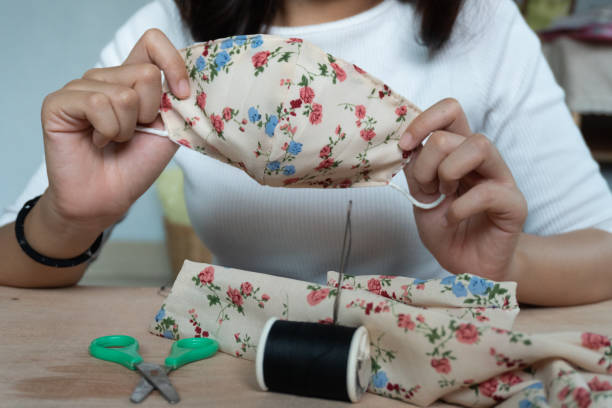 istock Making DIY masks at home sewing fabric mask handmade cotton protective equipment. 1221943811