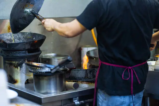 Photo of Chef prepares Asian food in the kitchen