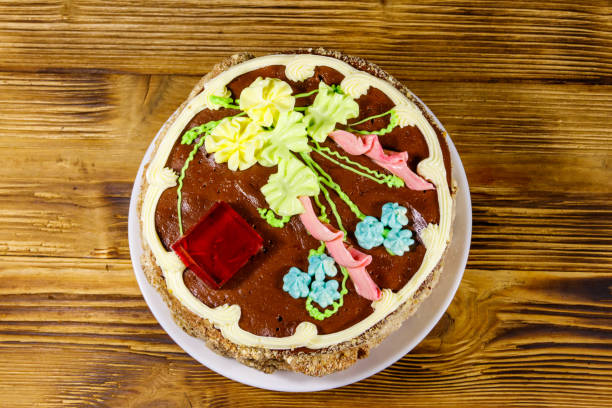 istock Kiev cake with cream, nuts and meringue on wooden table. Top view 1221947184