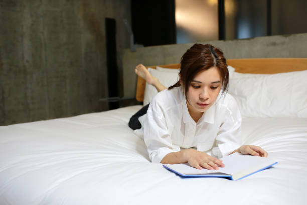 istock woman reading at home on the bed 1221952319