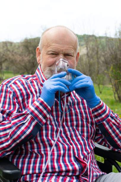 istock Elderly man with oxygen mask in a wheelchair 1221953529
