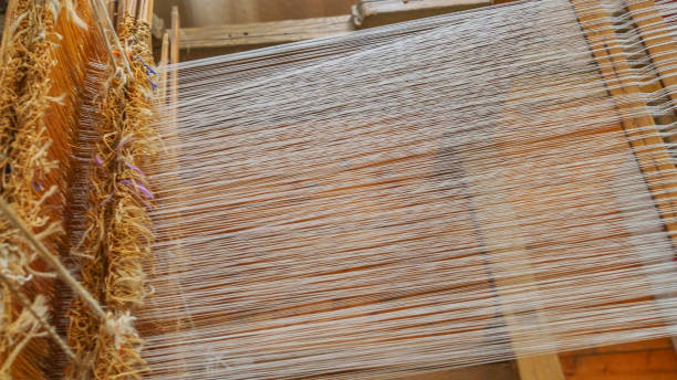 istock Close-up of threads in a loom. Rustic concept. Space for text. 1221954045