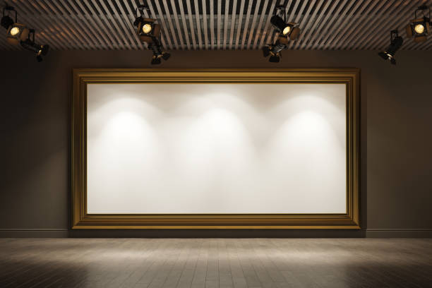 istock Big empty picture frame on the wall. Empty room interior with spotlights. 1221954226