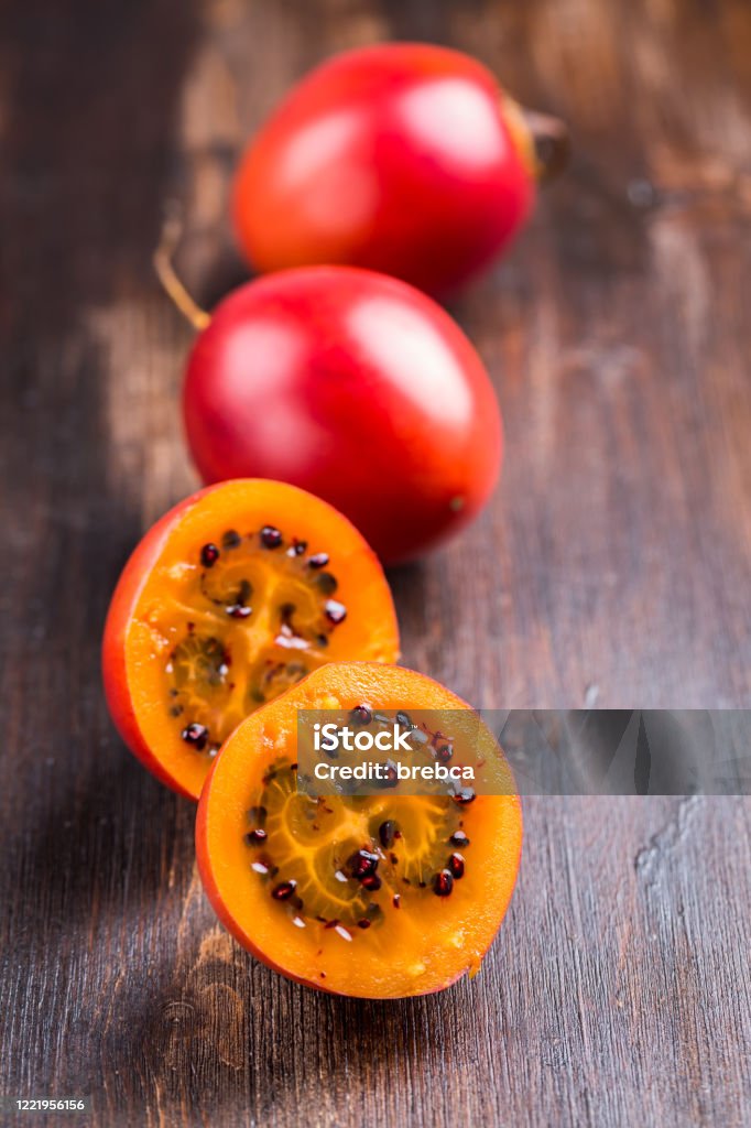 Fresh tamarillo fruit on wooden background Antioxidant Stock Photo