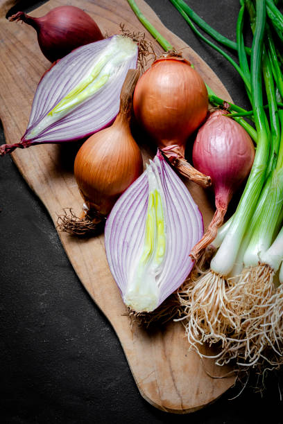 istock Fresh red and white onions on dark background 1221956248