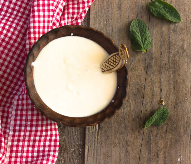istock Fresh sour cream in a ceramic dish on a wooden background 1221956701