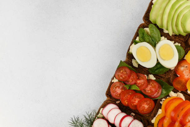 istock The border of different open faced sandwiches top view with copy space. 1221958507