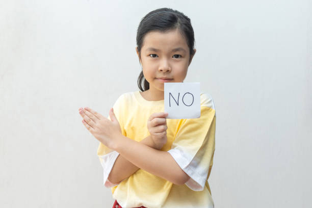 istock Girl holding paper with No 1221968705