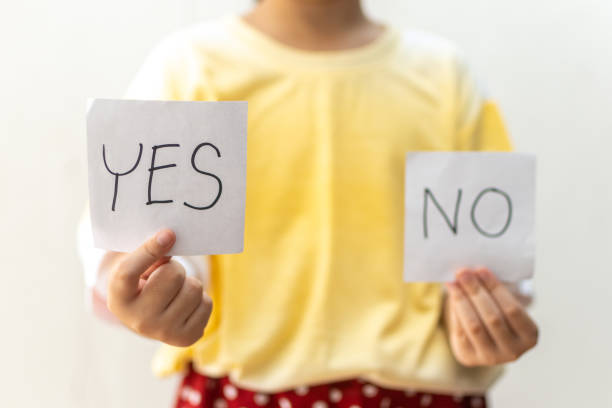 istock Girl trying to make a decision between Yes or No choice 1221968716