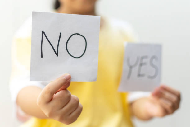 istock Girl holding paper with No 1221968723