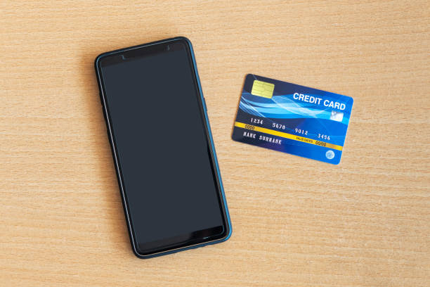 istock credit card and smartphone on table. On-line shopping on the internet using a smartphone 1221969305