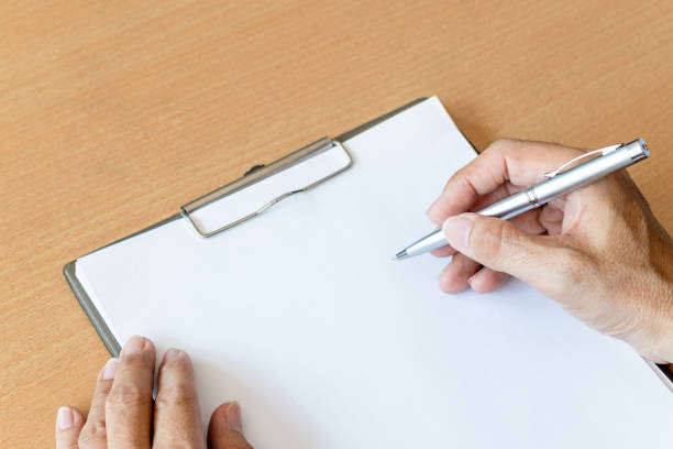 istock man hand with pen prepare to writing on paper 1221969320