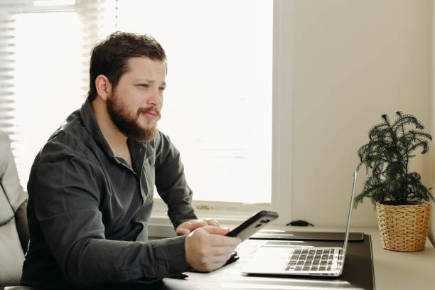 istock financial analyst using smatrphone and laptop working 1221971750