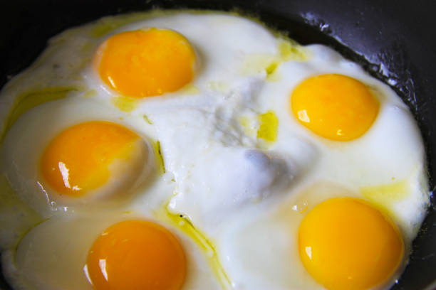 istock Morning roasted whole eggs on the black pan and dill over 1221971870