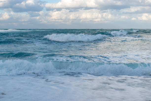 istock Blue sea with waves and sky with clouds before storm. 1221972056