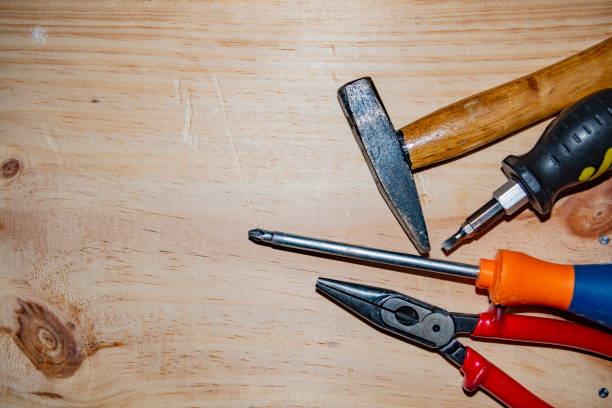 istock Kit of working tools on wooden background 1221973065