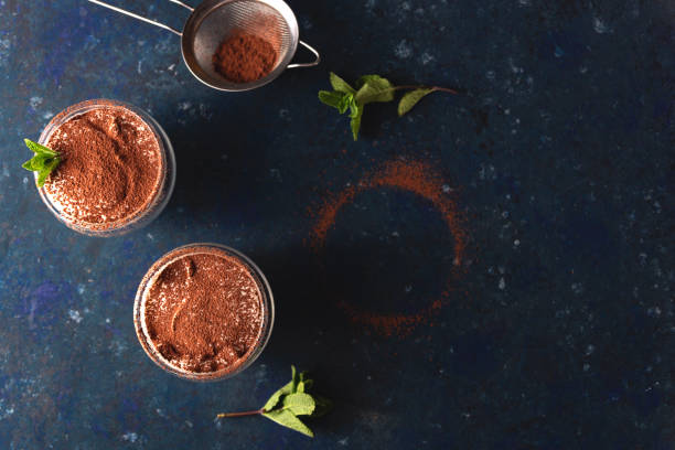 istock Two servings of tiramisu garnished with cocoa and mint 1221973167