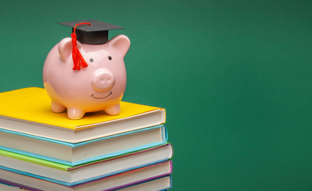 istock Piggy bank in a graduate hat on stack of books 1221973210