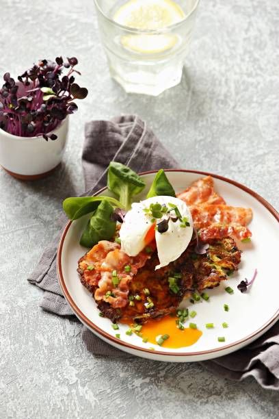 istock Zucchini fritters with poached egg and fried bacon. 1221973890