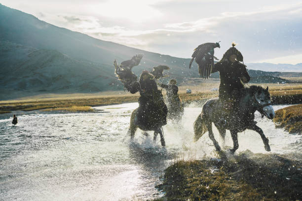 istock Eagle hunters riding through  the river in Mongolia 1221974046