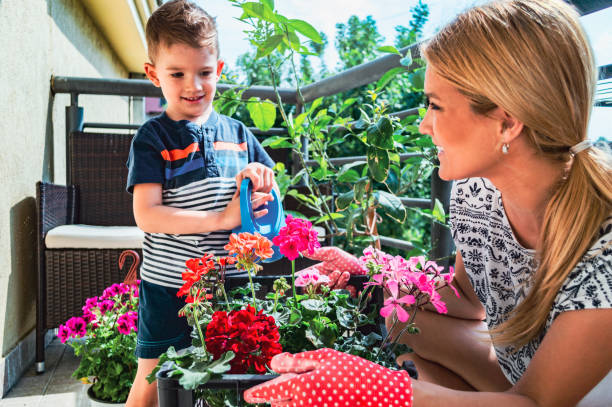 istock Child helping single mother with plants 1221975068