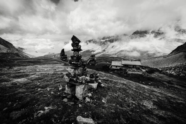A stone feature made of rocks sitting high up in the French Alps during a cloudy day stock photo