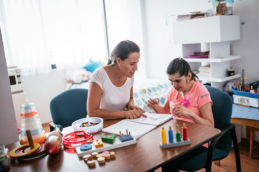 Mother with child with disability improving their skills and knowledge during quarantine time