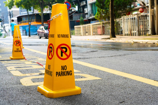 istock Plastic yellow cones forbidding parking nearby 1221978893